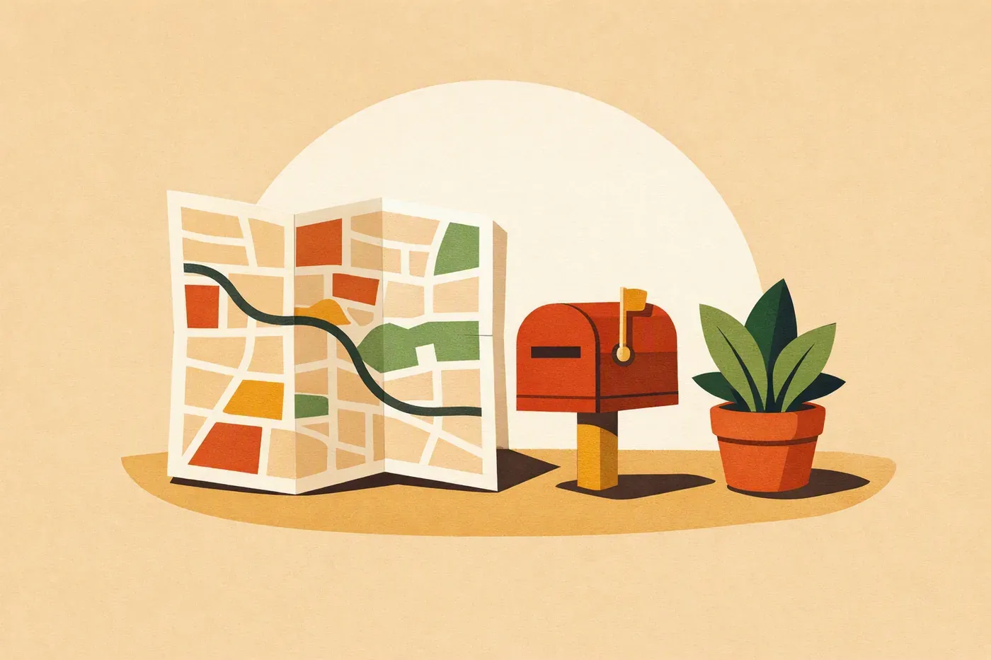 Un plan de ville plié, une boîte aux lettres miniature et une plante en pot.
