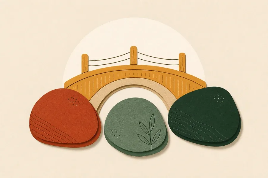 Un petit pont ocre relie trois galets verts et terracotta.